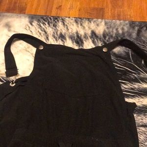 Black overalls fairly worn